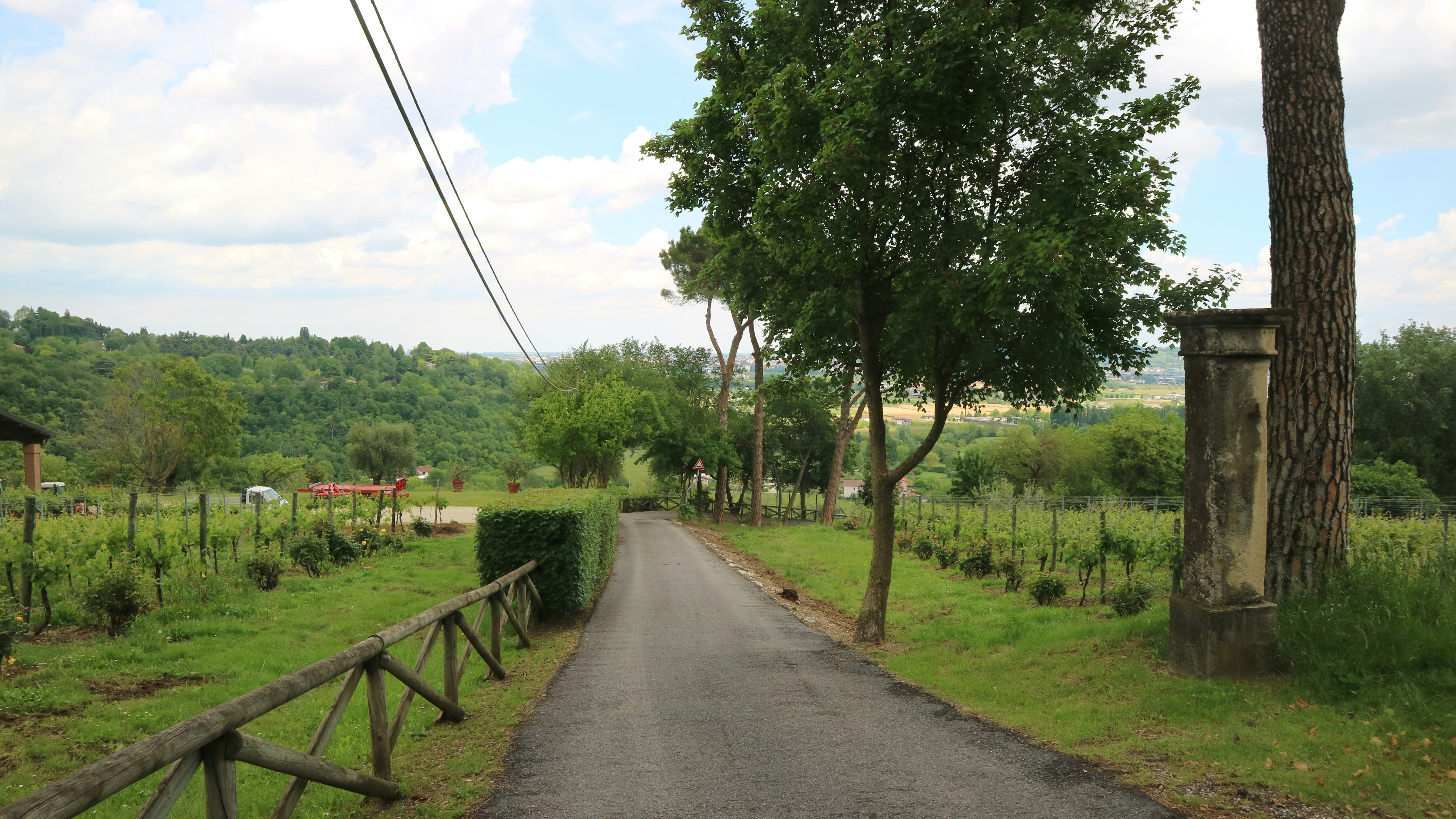 a paved road with a wooden fence on both sides