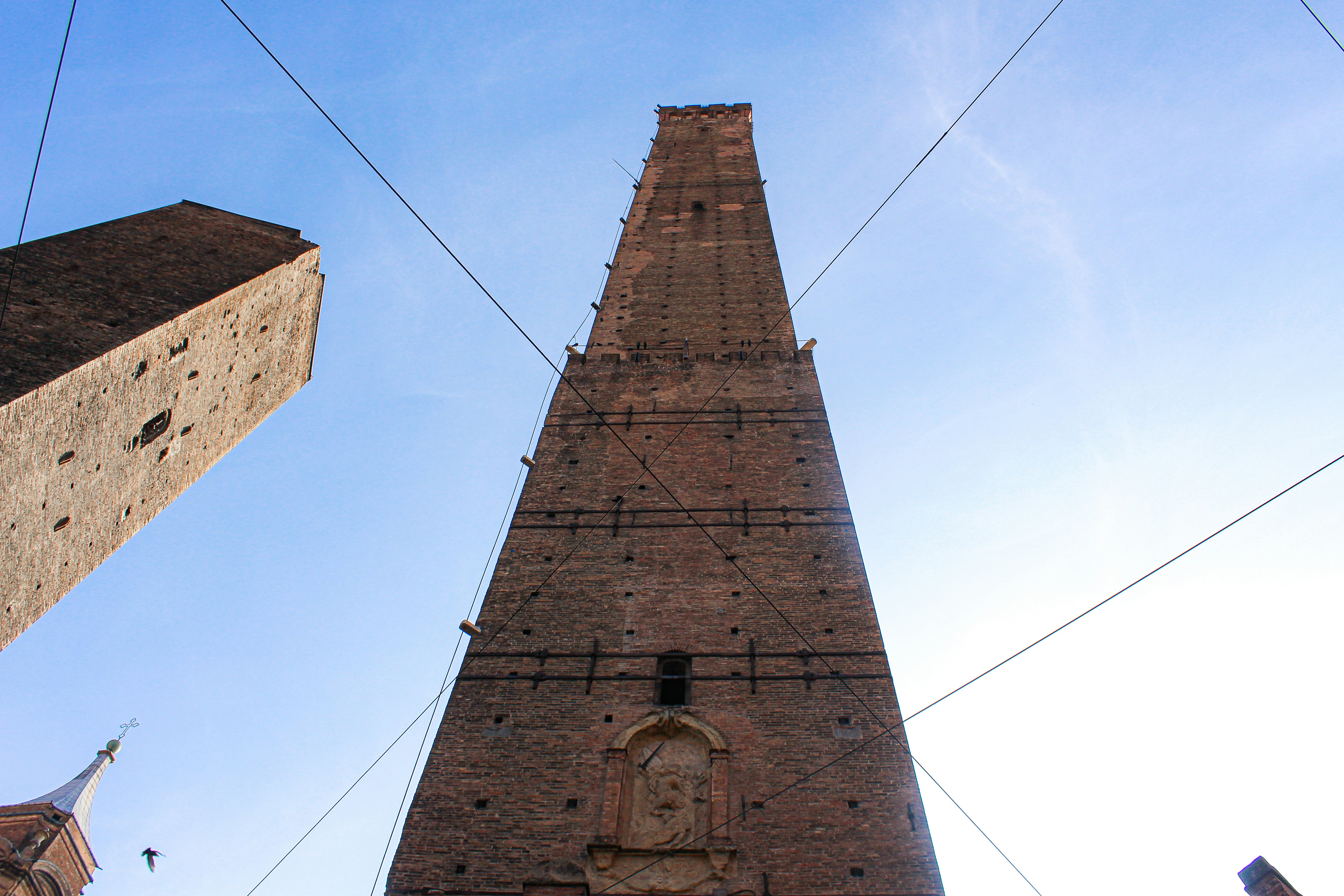 a tall brick tower with a clock on it's side