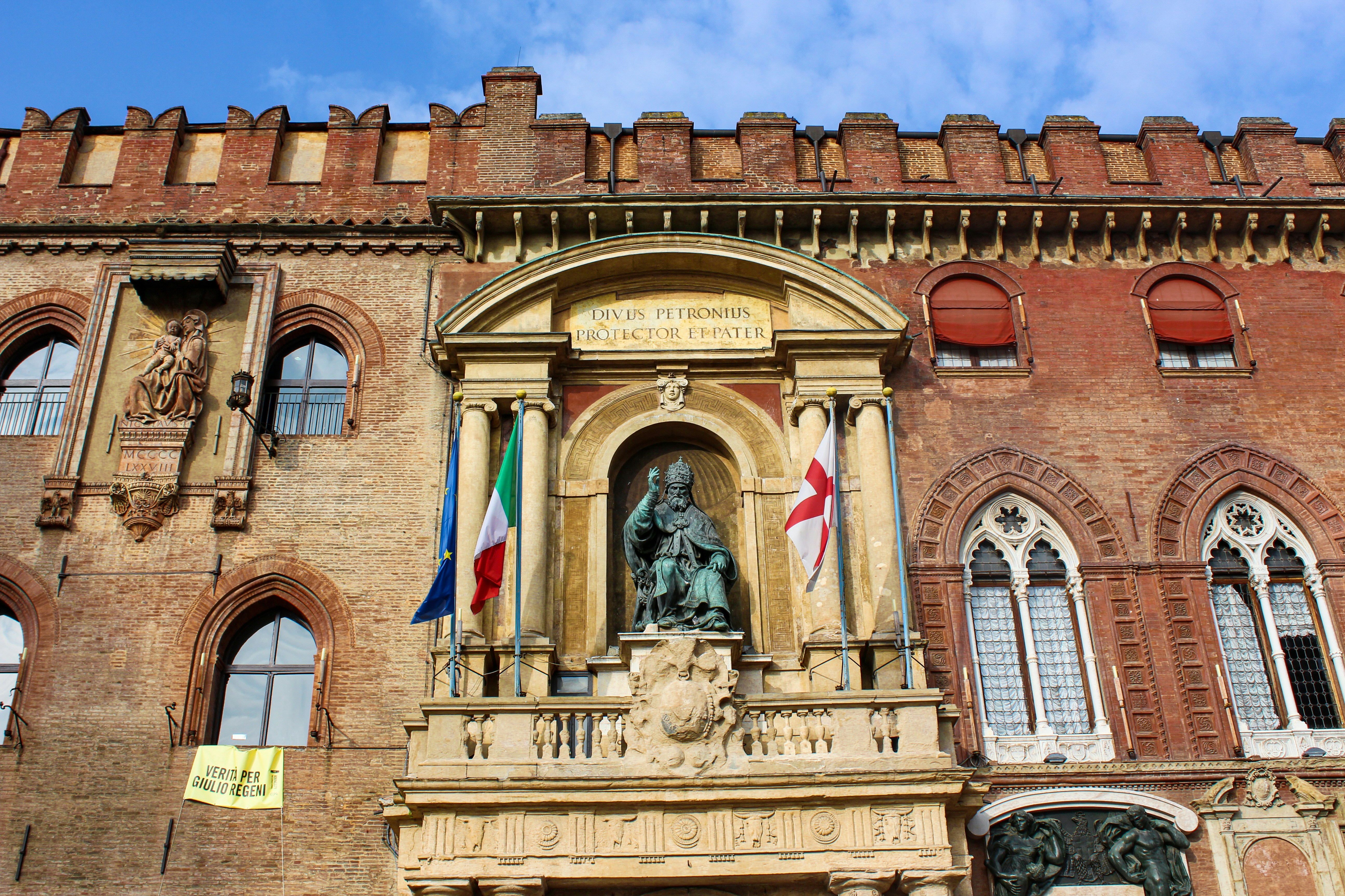 a large building with a statue of a man in front of it