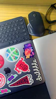A cozy workspace in Athens with gadgets and stickers scattered on a desk