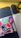 Close-up of a laptop covered in colorful, witty vinyl stickers with a cozy workspace in the background.