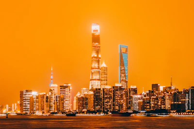 Futuristic city skyline at night glowing with orange neon lights, setting the vibe.