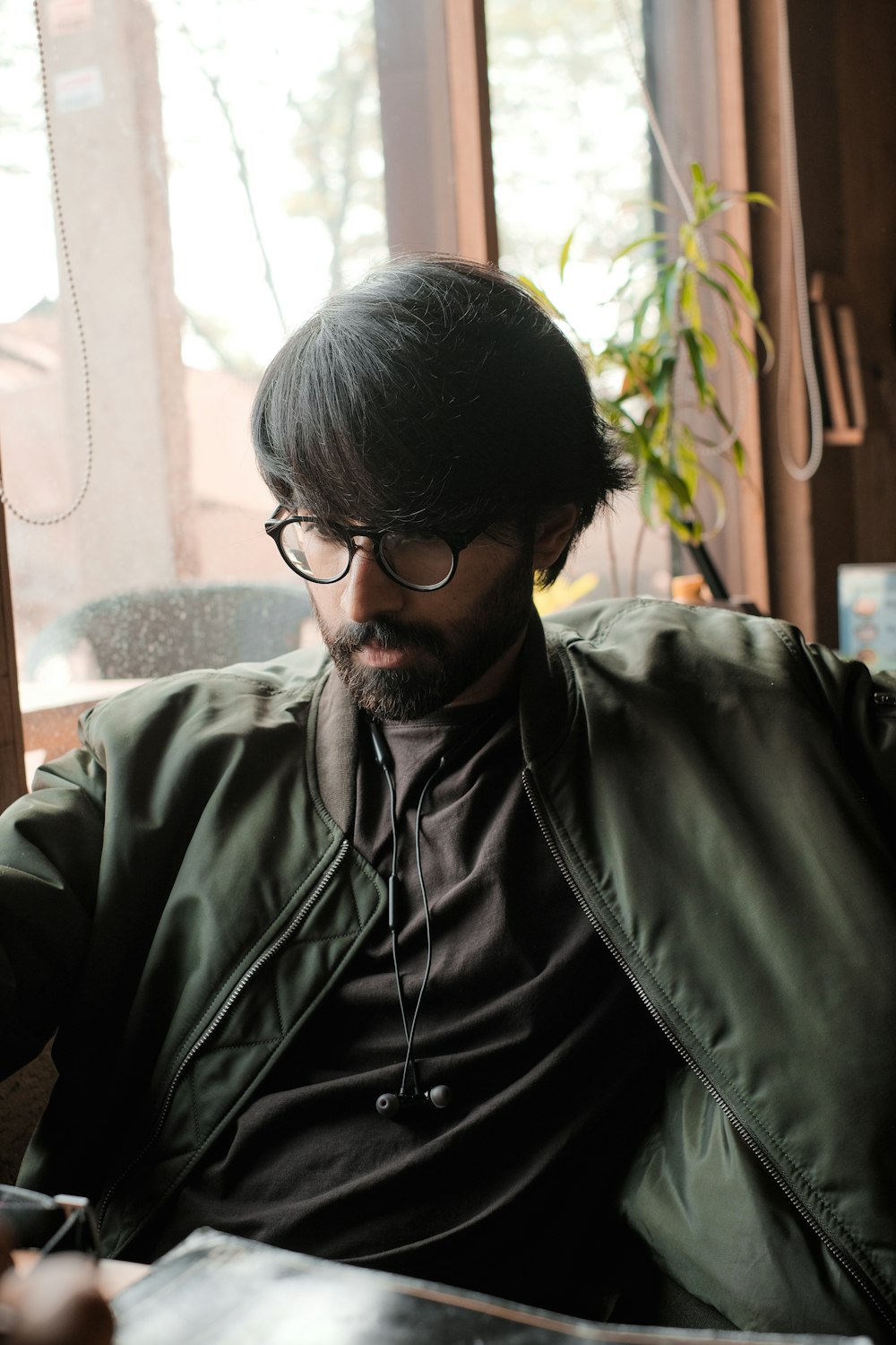 a man sitting in a chair looking at his cell phone