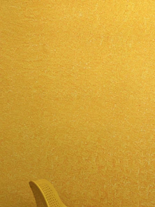 A vibrant living room wall freshly painted in bright yellow with smooth, even finish.