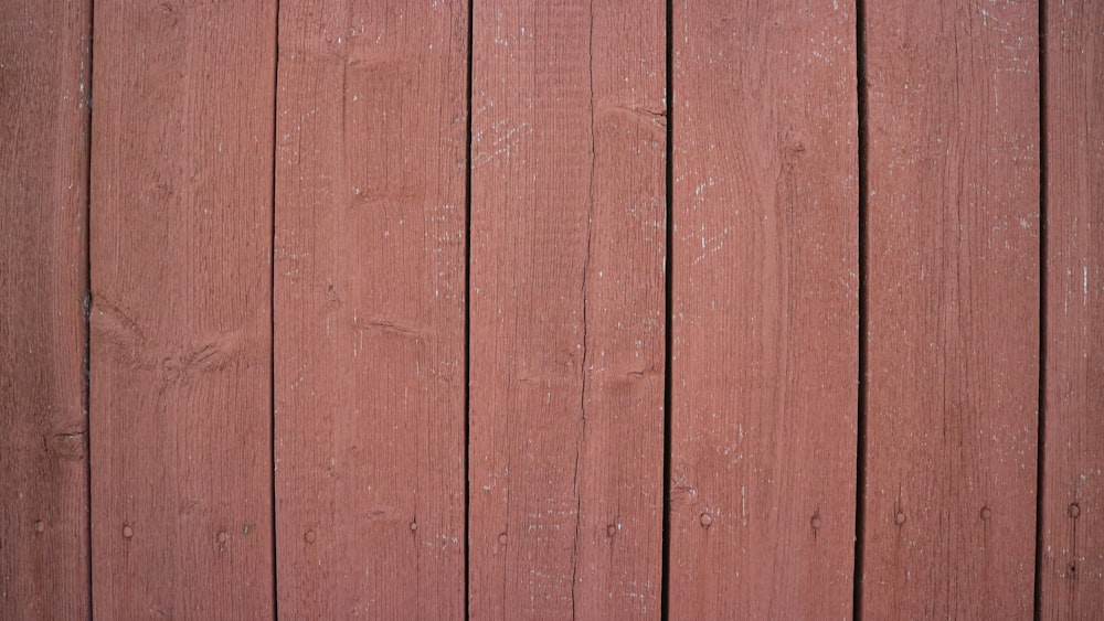 a close up of a red wooden fence