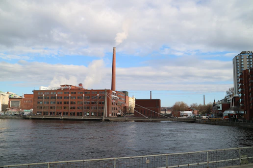 a river with a factory in the background