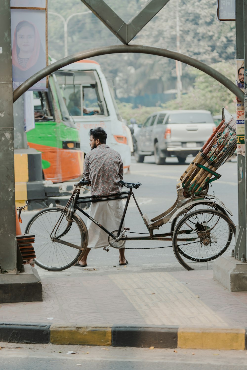 a man on a bike with a cart attached to it