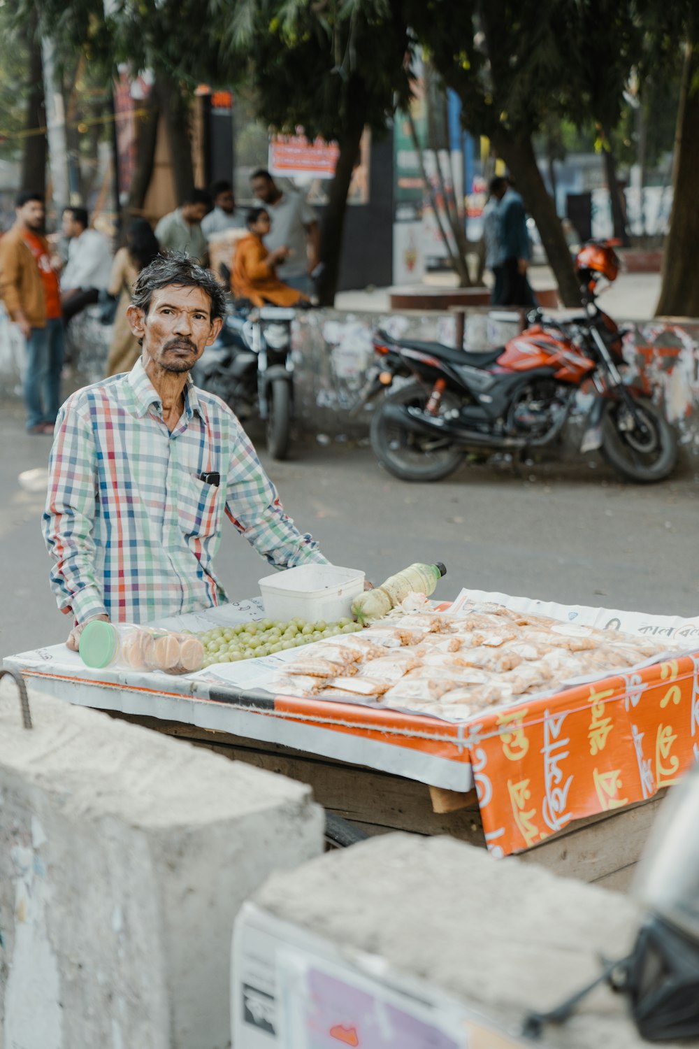 a man standing next to a table filled with food