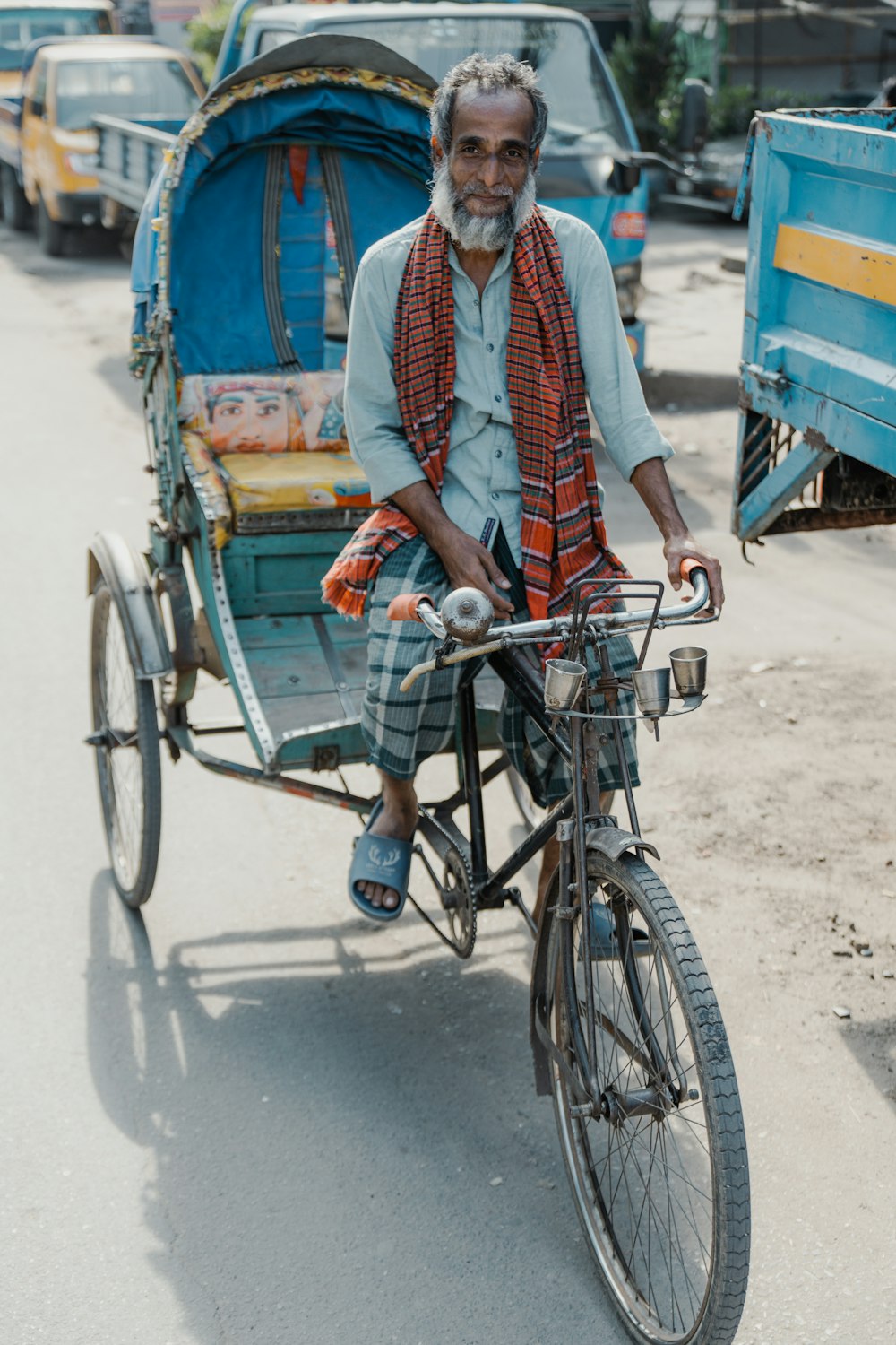 a man riding a bike with a cart attached to it