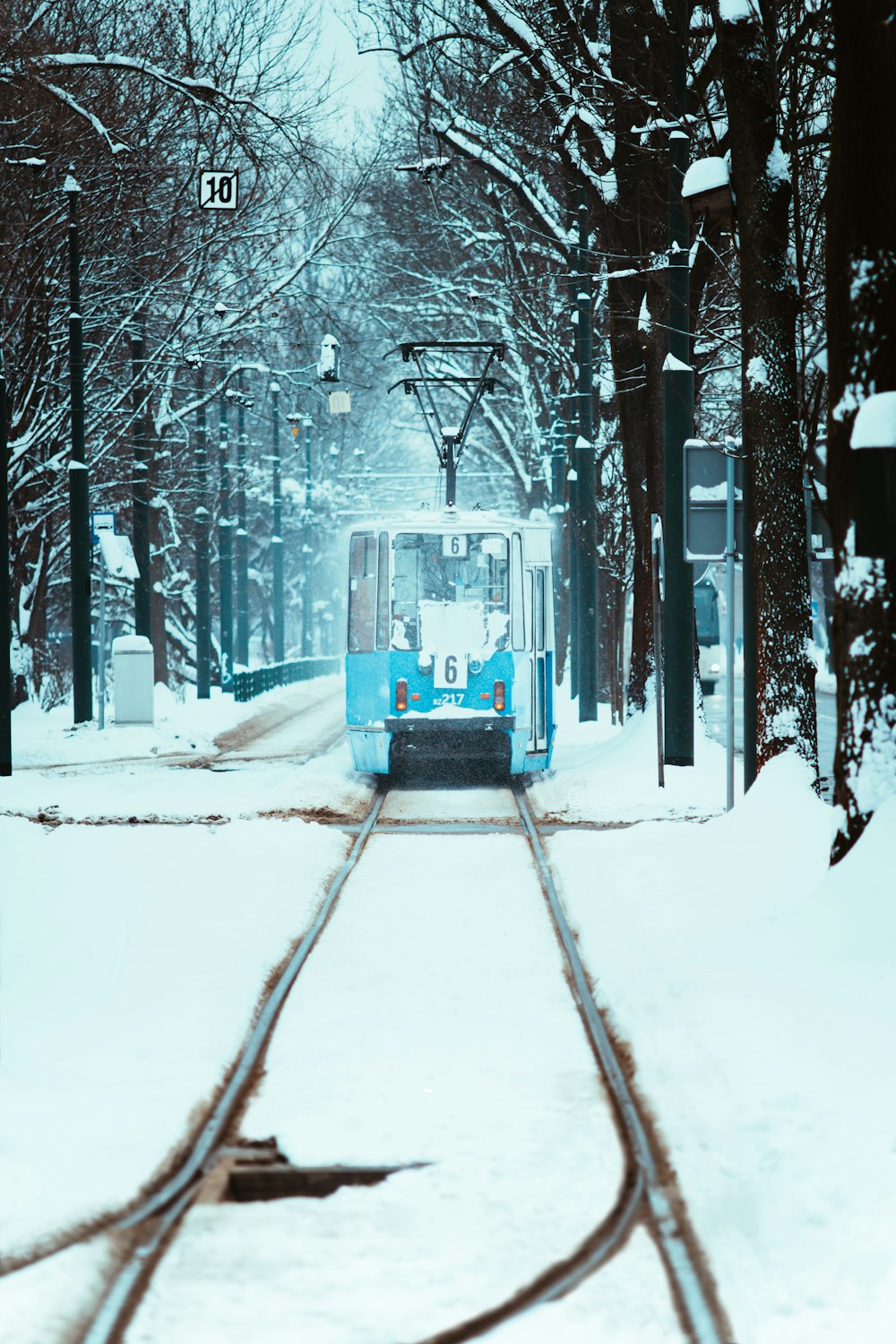 a train traveling through a snow covered forest