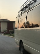 Mobile locksmith van parked outside a customer's home at sunset.
