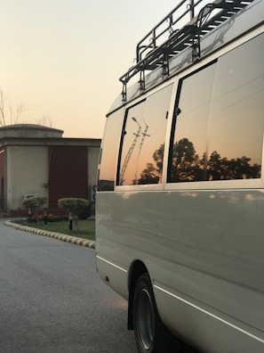 Trusted HVAC service van parked in front of a customer's house at sunset.