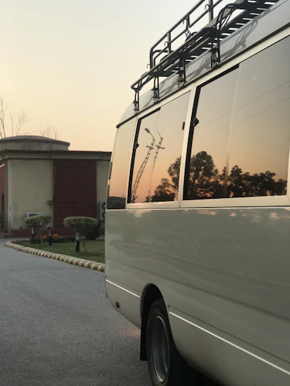 A candid photo of a plain white van parked on a quiet street at sunset, hinting at untold stories inside.