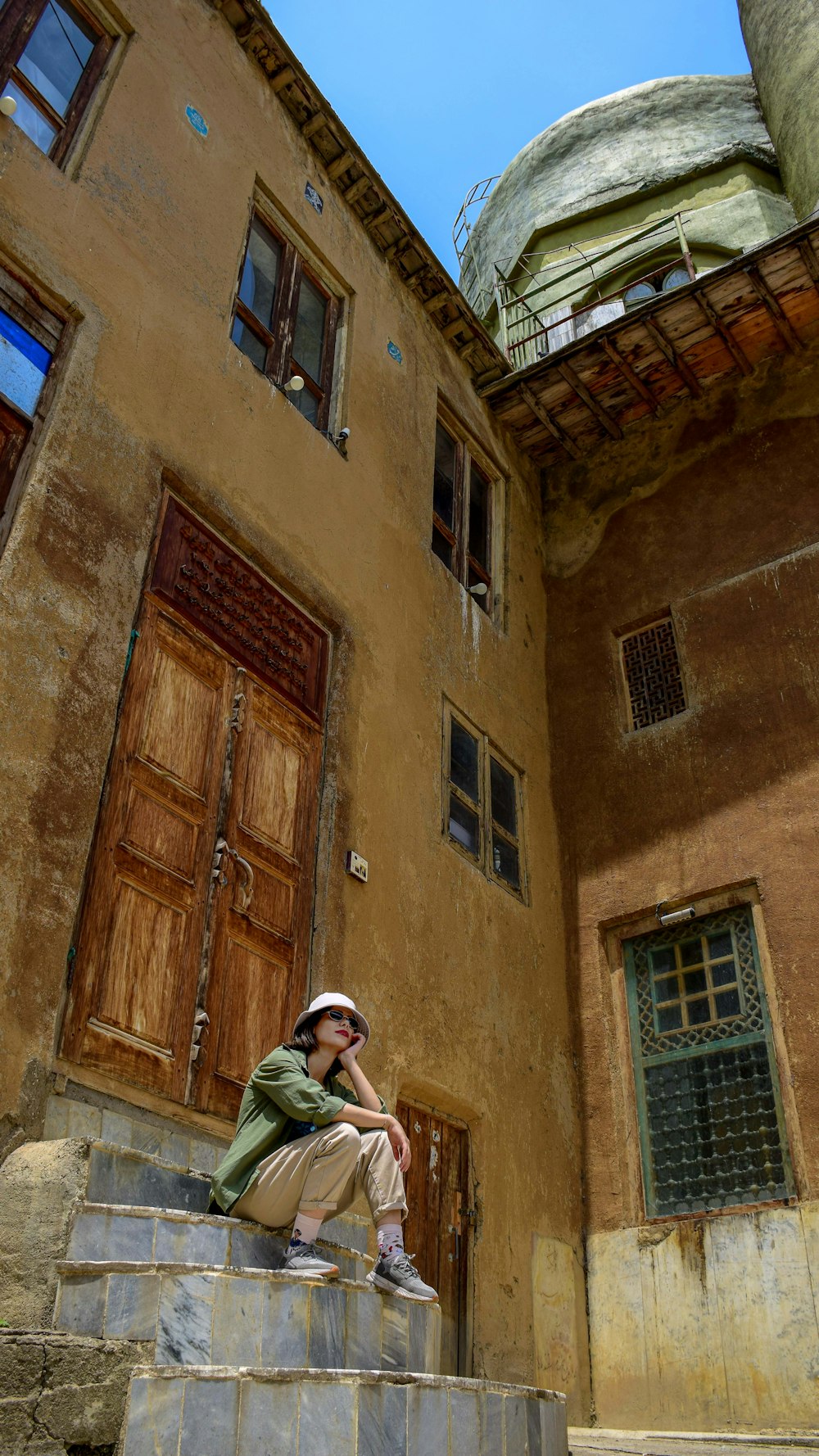 a man sitting on steps in front of a building