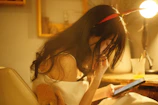 A focused adult woman reading a learning guide on a tablet in a cozy home setting.