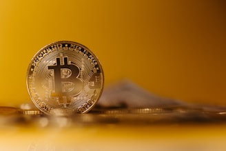 Close-up of a physical Bitcoin coin resting on a digital ledger background