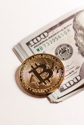 a bitcoin sitting on top of a pile of money