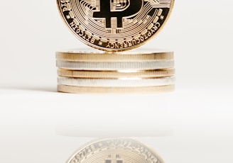 a stack of gold bitcoins sitting on top of each other