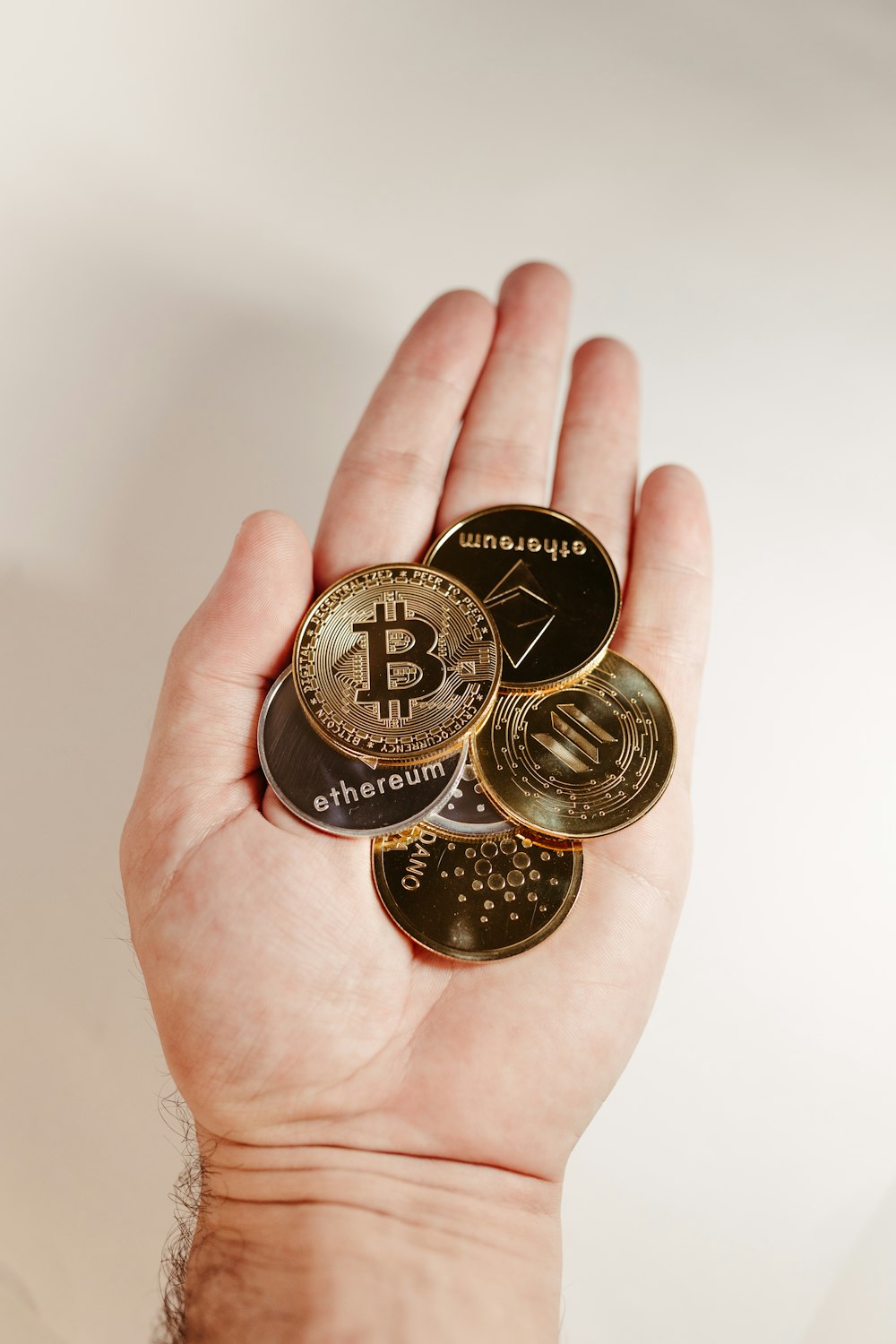 a person holding a bunch of bitcoins in their hand