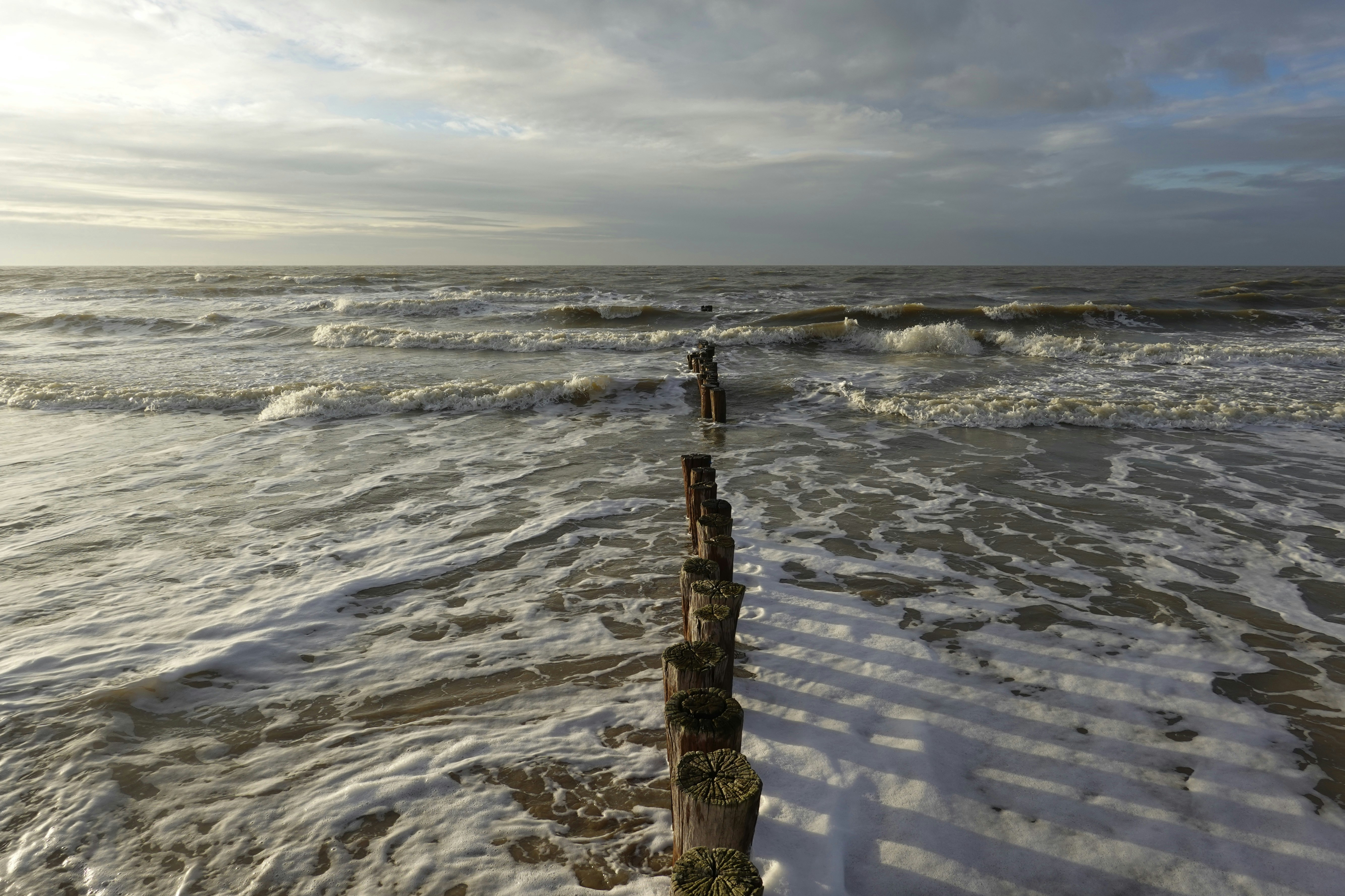 a person standing on a beach next to the ocean