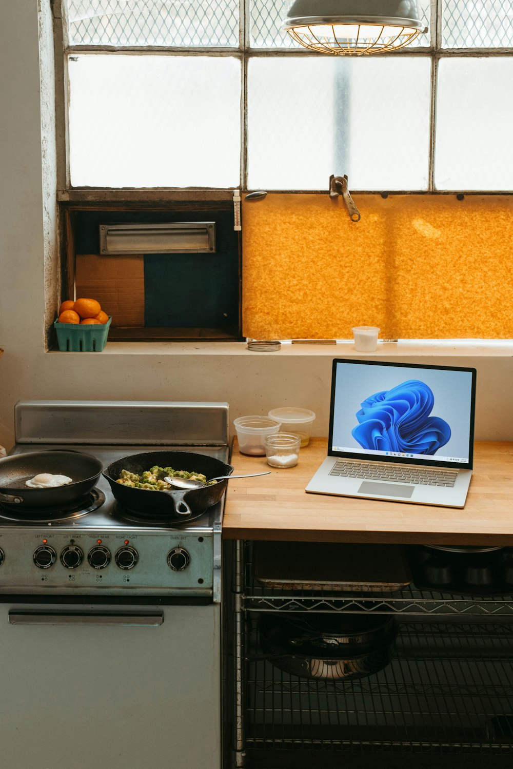 a laptop computer sitting on top of a stove top oven