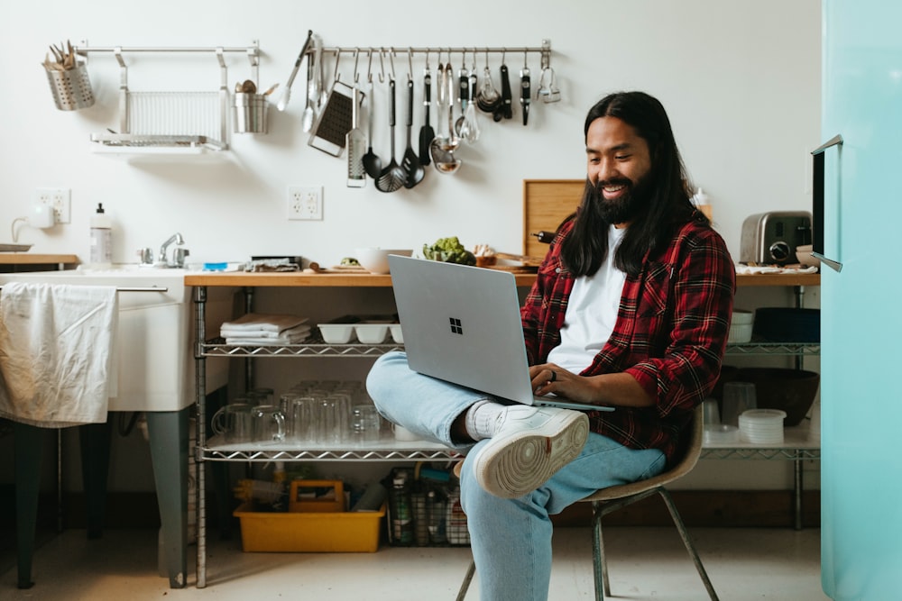 a man sitting in a chair with a laptop