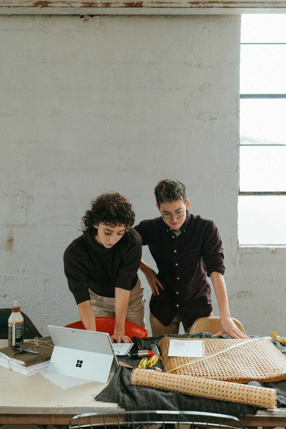 a couple of people that are standing in front of a table