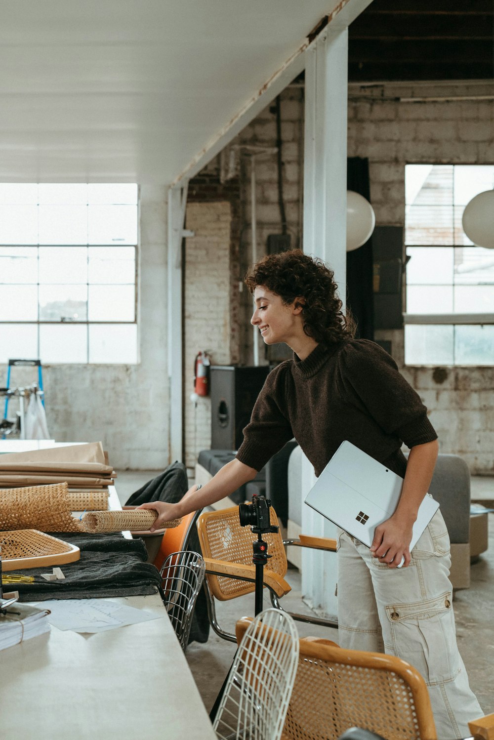 a woman standing in a room with lots of furniture