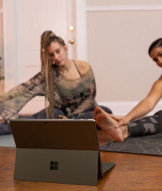 a couple of women sitting on top of a wooden floor