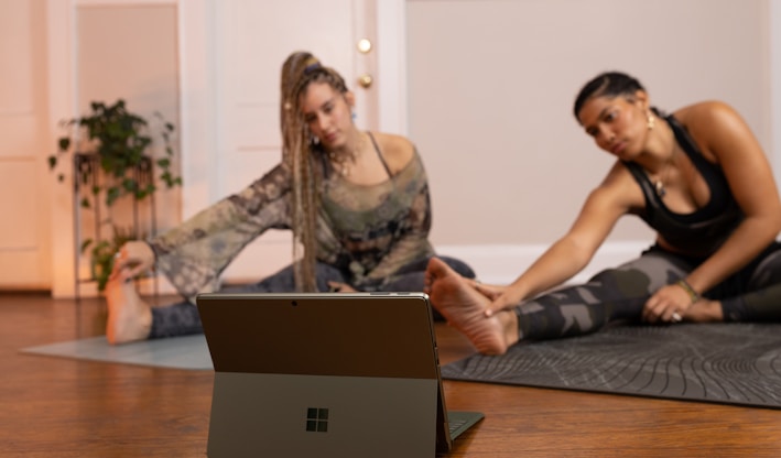 a couple of women sitting on top of a wooden floor