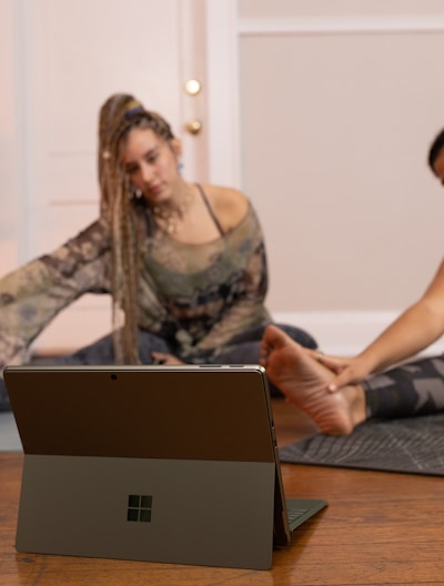 a couple of women sitting on top of a wooden floor