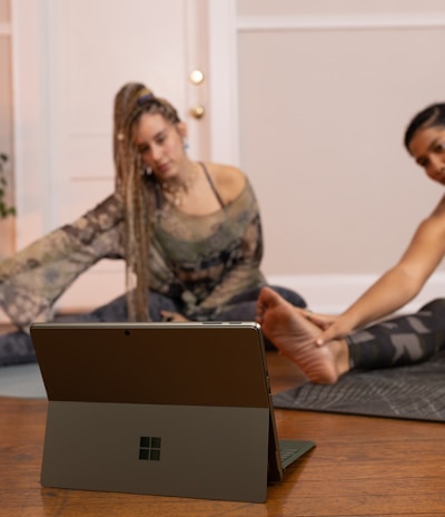 a couple of women sitting on top of a wooden floor