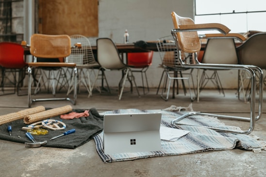 A cozy workspace with various DIY tools and router bits neatly arranged on a wooden table.