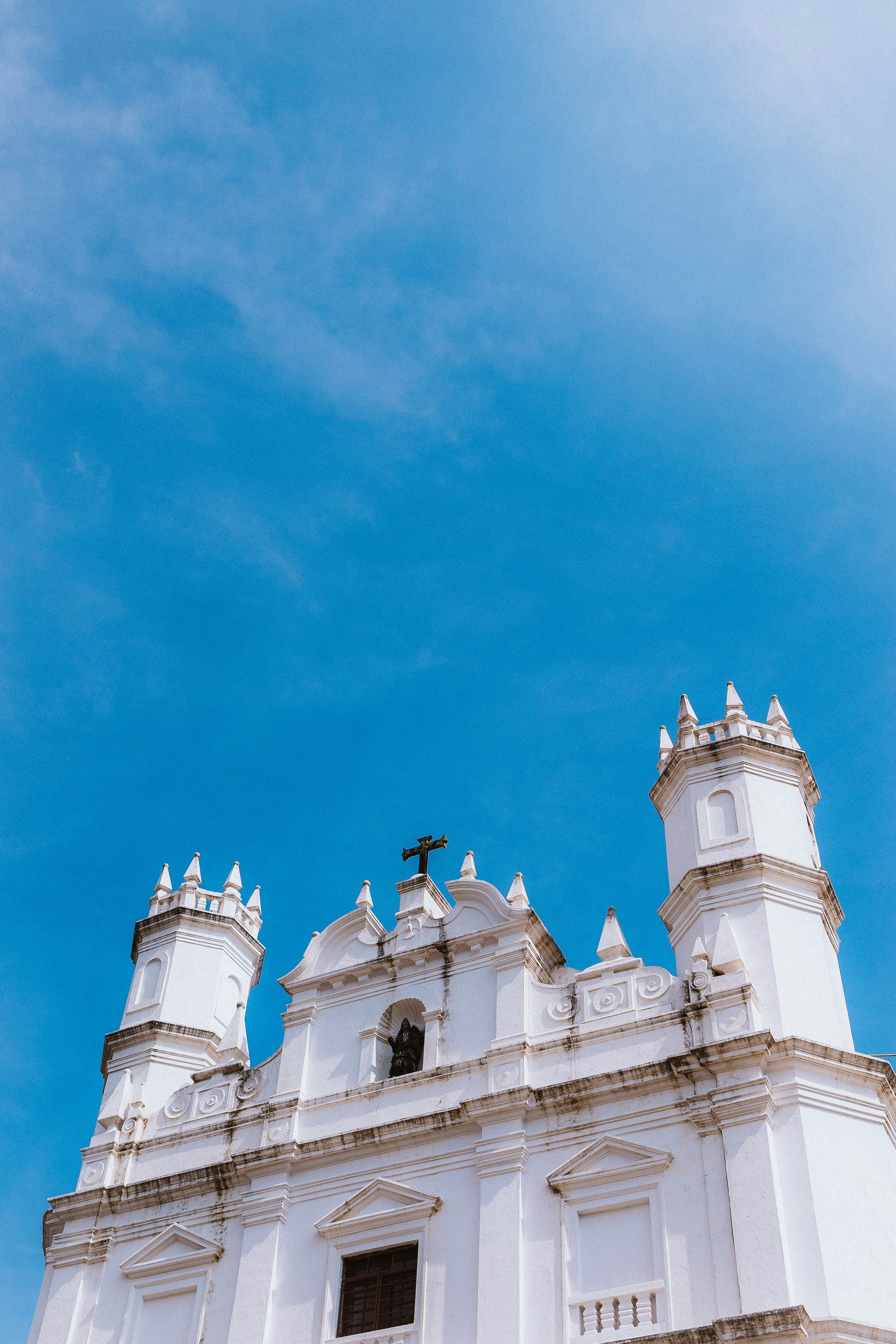 a large white building with a cross on top of it