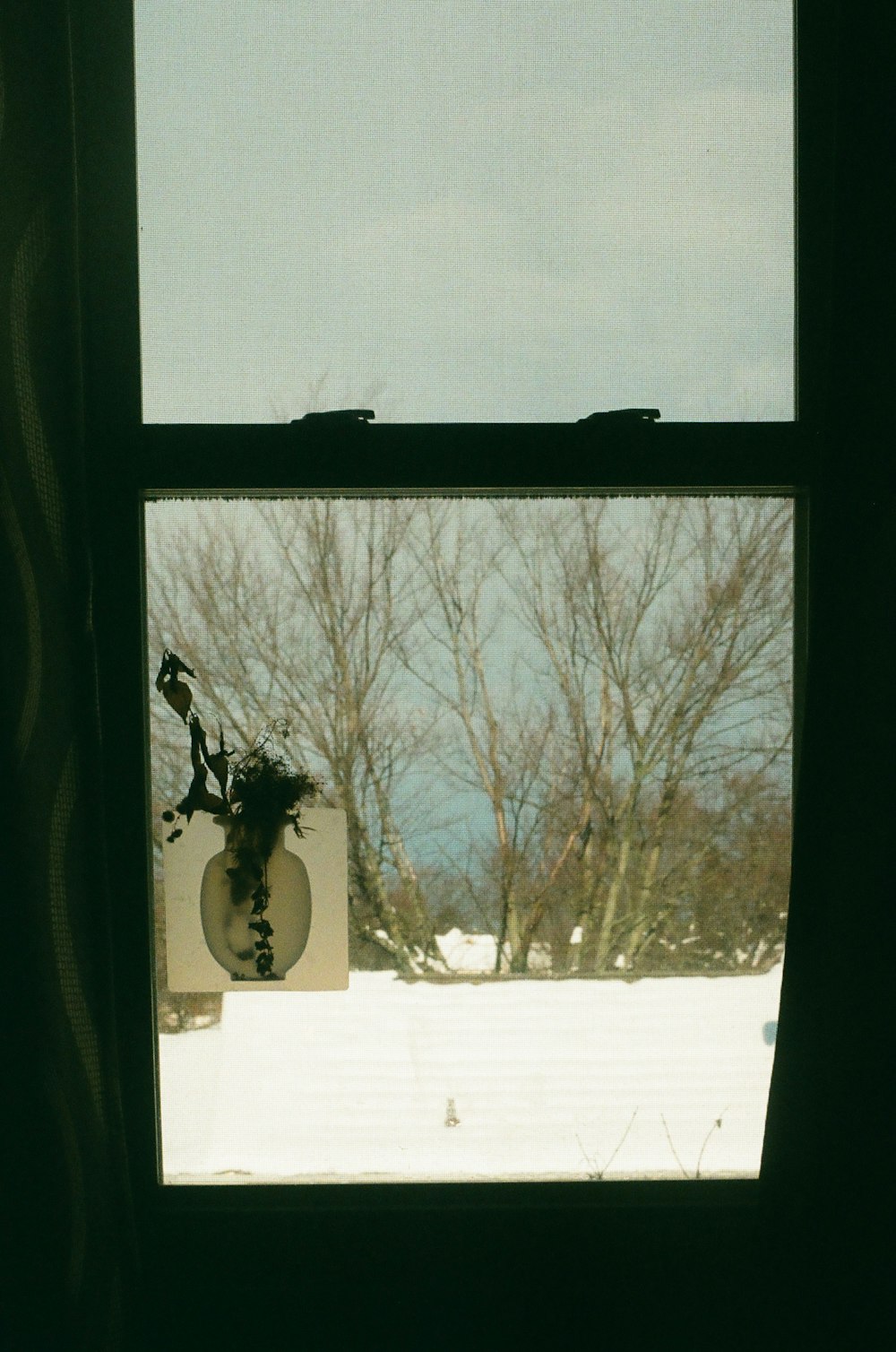 a view of a snowy field through a window