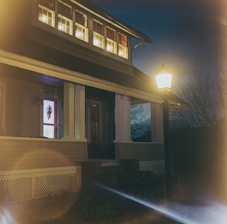 A warm, welcoming home with a porch light glowing in the evening, symbolizing hope.