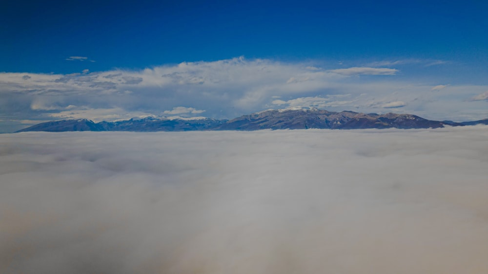 a view of a mountain range in the clouds