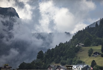 A serene view of the cottage surrounded by lush green mountains.