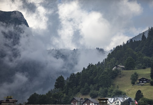 A serene view of the cottage surrounded by lush green mountains.
