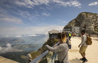 Visitors enjoying a guided tour at the summit of Montana Redonda with panoramic ocean views.