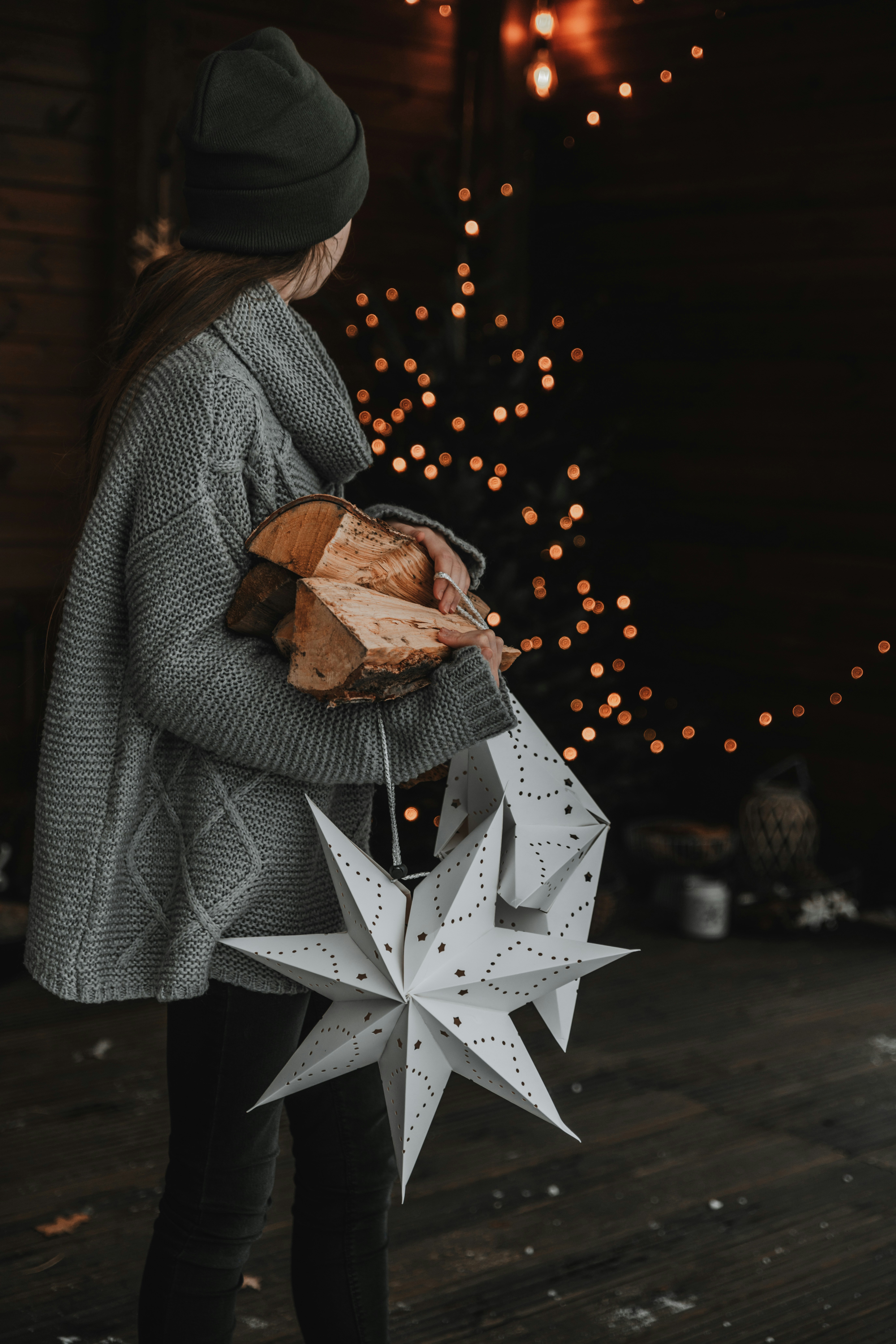 a woman holding a star ornament in her hands