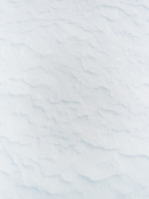 a man riding skis down a snow covered slope