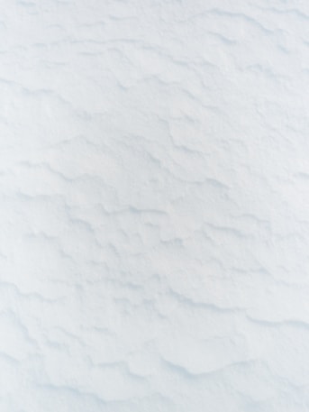 a man riding skis down a snow covered slope