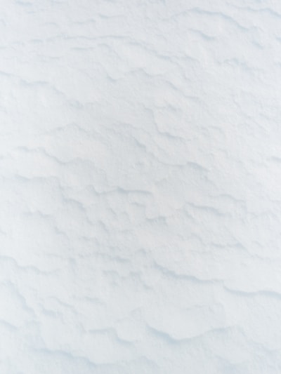 a man riding skis down a snow covered slope