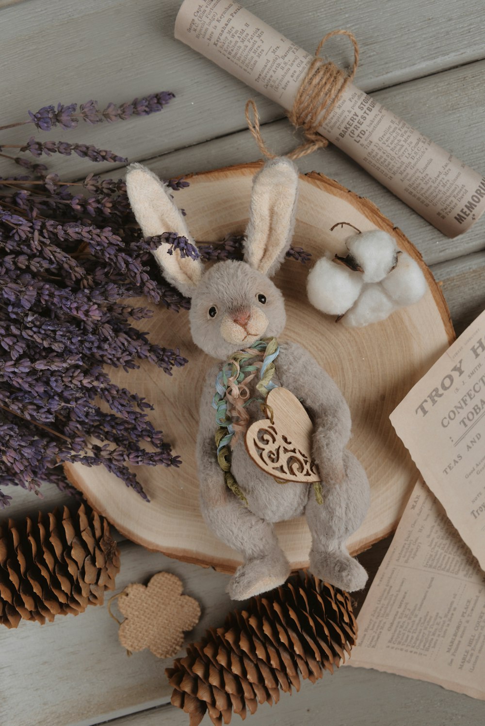 a stuffed rabbit sitting on top of a wooden plate