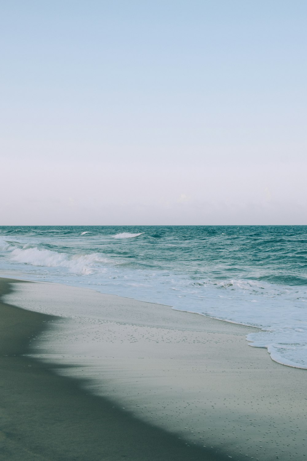 a beach with waves coming in to the shore