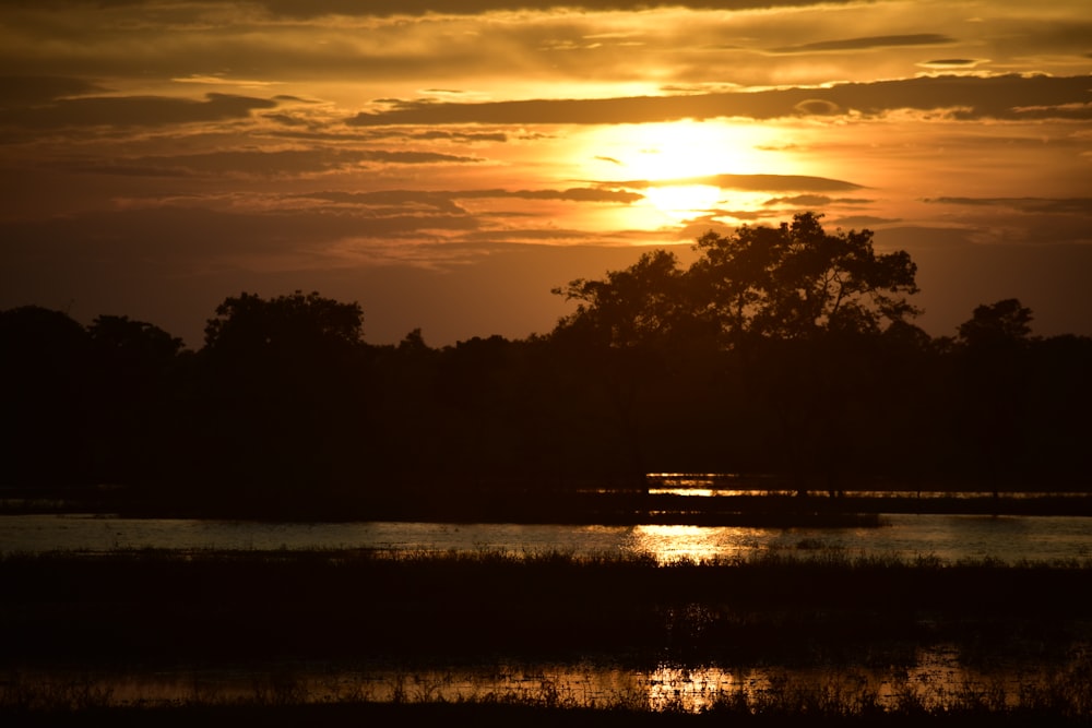 the sun is setting over a body of water