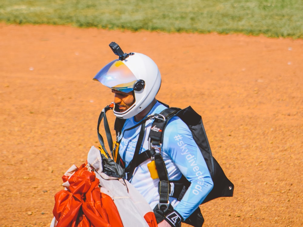 a man wearing a helmet and carrying a bag