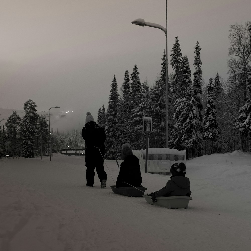 a couple of people that are sitting in the snow