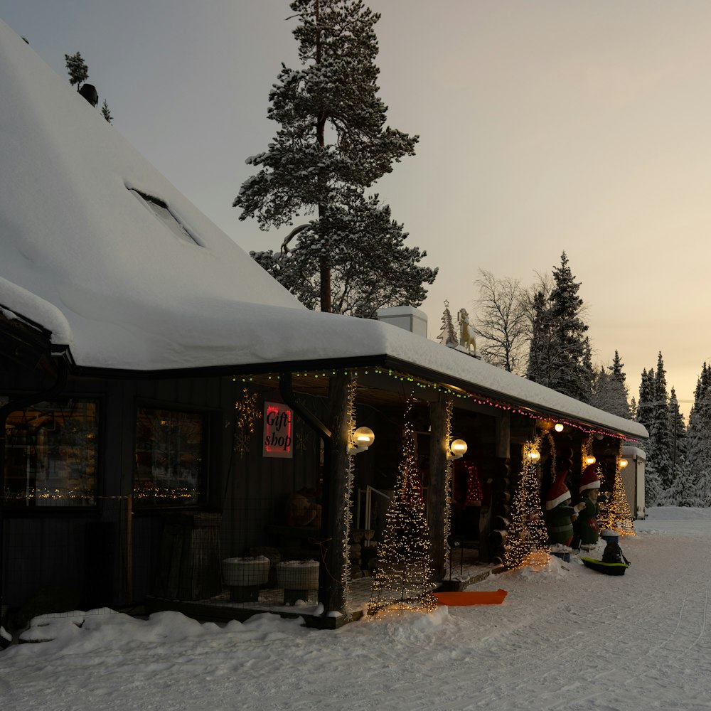 a group of people standing outside of a building covered in snow